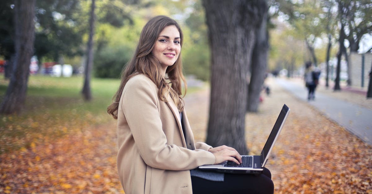 What kind of chocolate should I use to coat homemade turtles? - Joyful confident woman using netbook in park