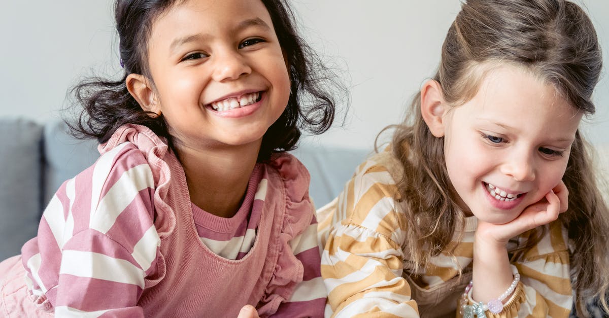 What kind of pan works best with a waterbath? - Smiling Hispanic child against sincere girlfriend in striped wear leaning on hand in house room