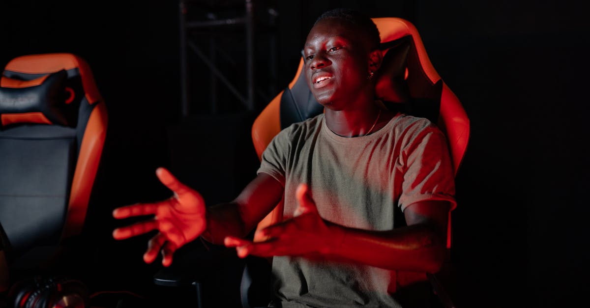 What kind of reaction is this? - Man in Gray Crew Neck T-shirt Sitting on Red Chair