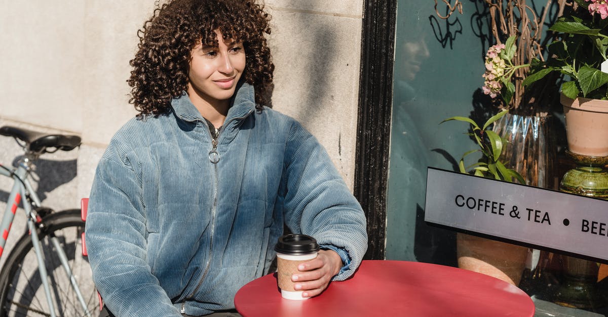 What kind of tea do you boil for 45minutes? - Smiling ethnic woman with coffee to go in street cafe