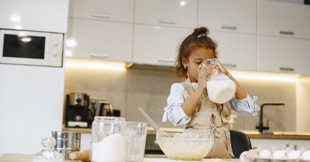 What kinds of milk are low in carbs? - Girl Drinking Milk from Clear Glass Pitcher