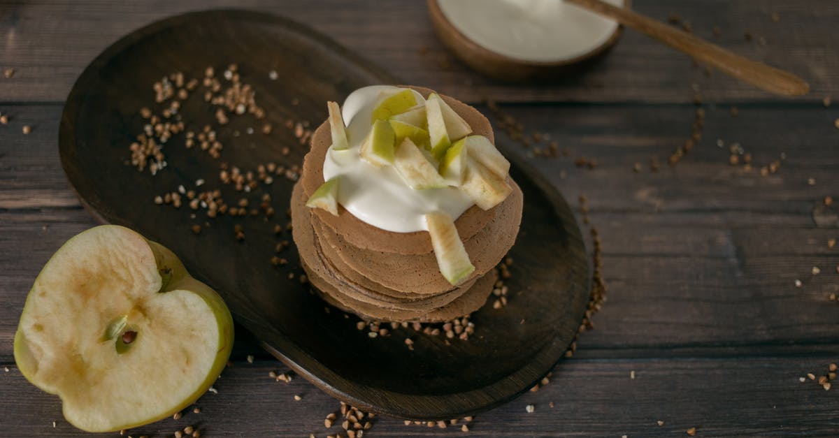 What made my pancakes taste fizzy? - From above of tasty homemade pancakes made of buckwheat topped with sour cream and apples served on wooden table in kitchen