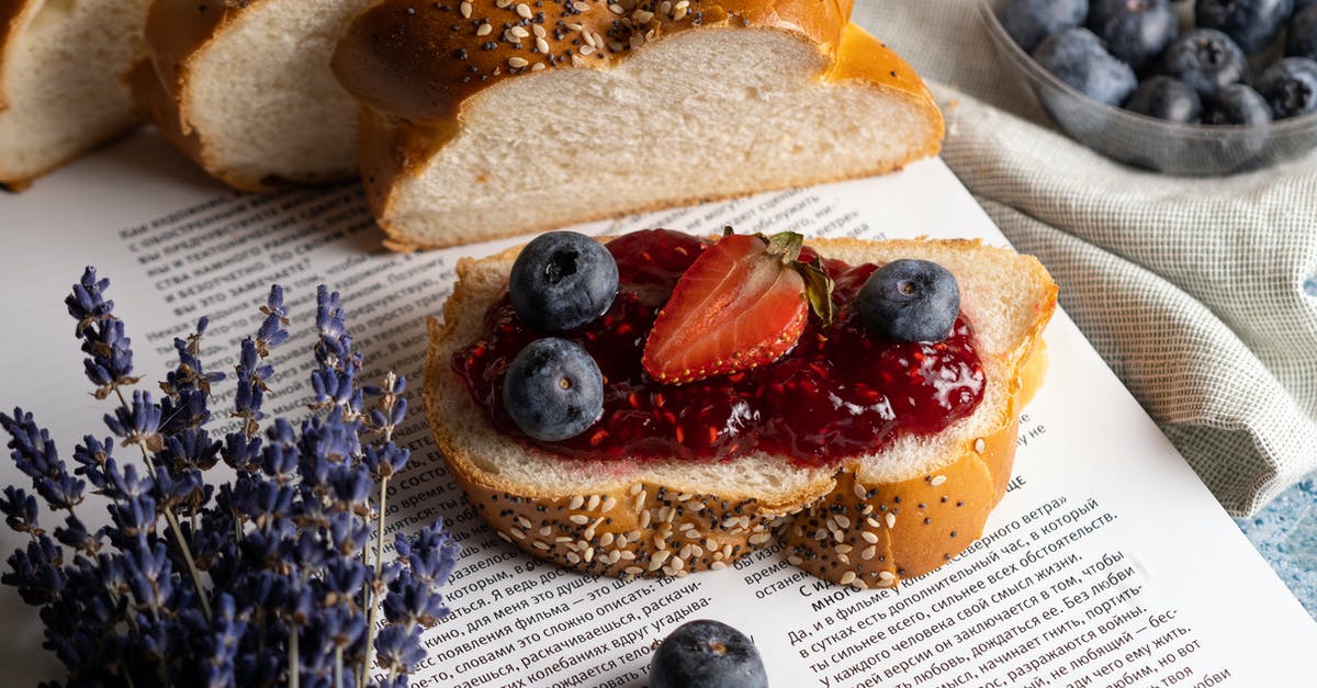 What makes a bread either close or open crumbed/textured? - Fresh Slice of Bread with Jam and Fruits Lying on Open Book