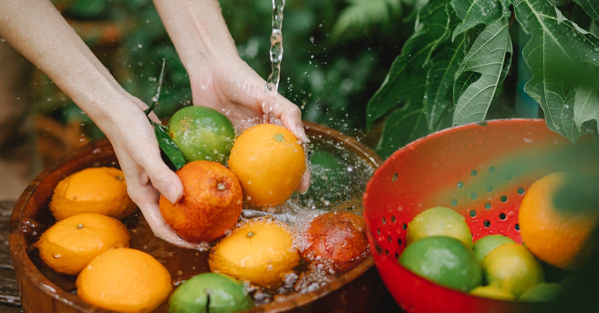 What nutrients are concentrated in citrus peels (not juice)? - Woman washing fresh fruits in tropical orchard
