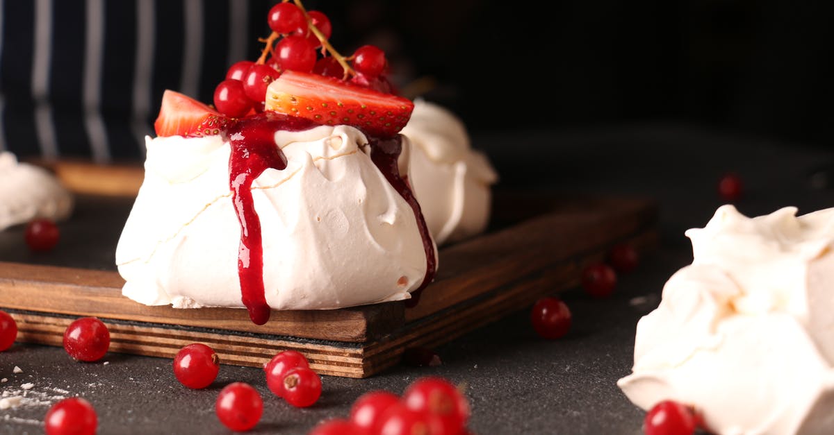 What part or kind of geoduck gives crunchy slender slices? - Unrecognizable cook decorating bright tasty meringue cake with fresh berries