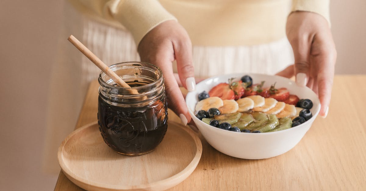 What preparation is done to banana peppers? - Person Preparing a Bowl of Sliced Fruits with Syrup