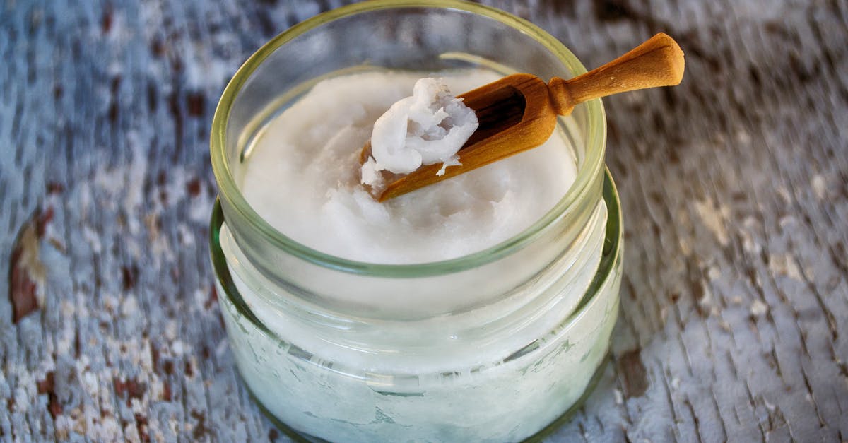 What quantity of coconut oil should be substituted for butter in a brownie mix? - Clear Glass Container with Coconut Oil