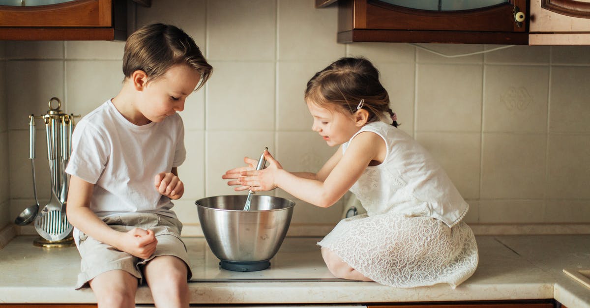 What role does a stoneware bowl play in the baking of Artisan bread? - Photo of Kids Playing in Kitchen Counter Top