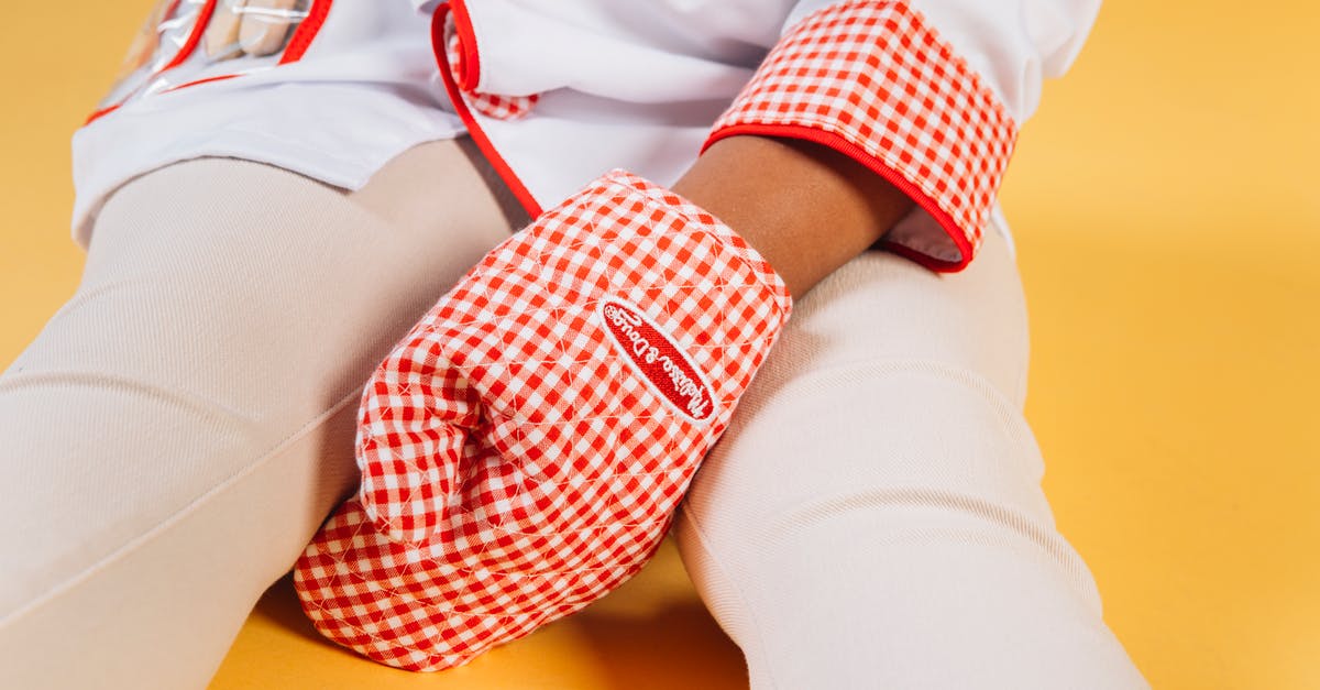 What role does a stoneware bowl play in the baking of Artisan bread? - Little child wearing chef uniform with oven glove