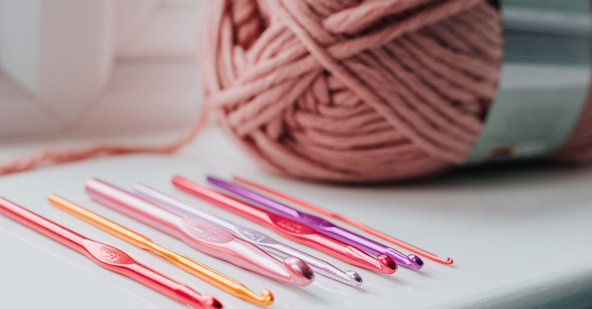 What setting on a thermomix would create a simmer? - Closeup of row of multicolored crochet needles and ball of beige threads for knitting in bright room