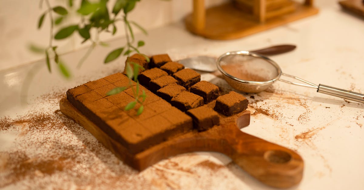 What should be added to brownies when reducing cocoa powder and vanilla extract? - Chocolate Brownie on Wooden Chopping Board on White Table