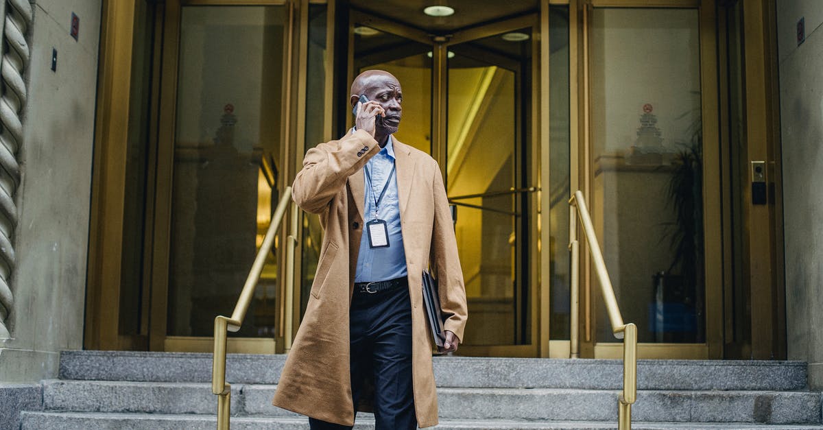 What should I use to build a parrilla? - Pensive black man talking on phone walking down stairs