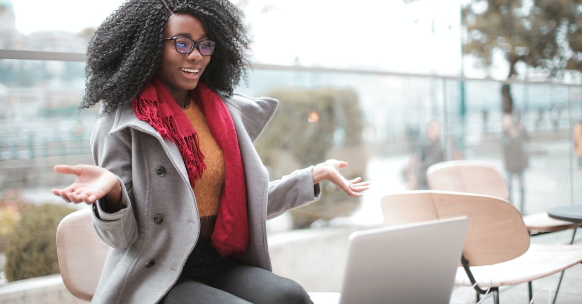 What to call this utensil - Happy excited African American female laughing and gesticulating while having video calling on laptop and sitting at modern cafe