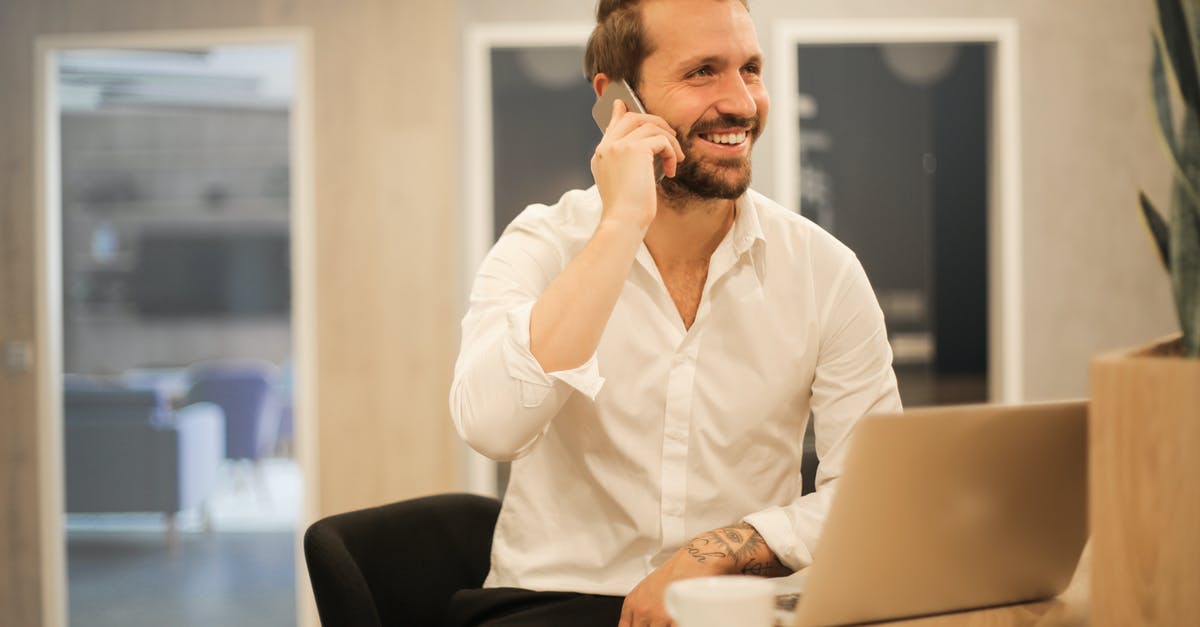 What to call this utensil - Smiling formal male with laptop chatting via phone