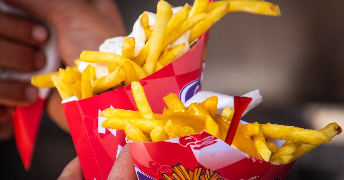 What to do with cheese that has fermented after vacuum packing? - Person Holding Two Potato Fries Packs