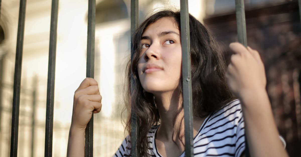 What to do with excess Wham bars - Sad isolated young woman looking away through fence with hope