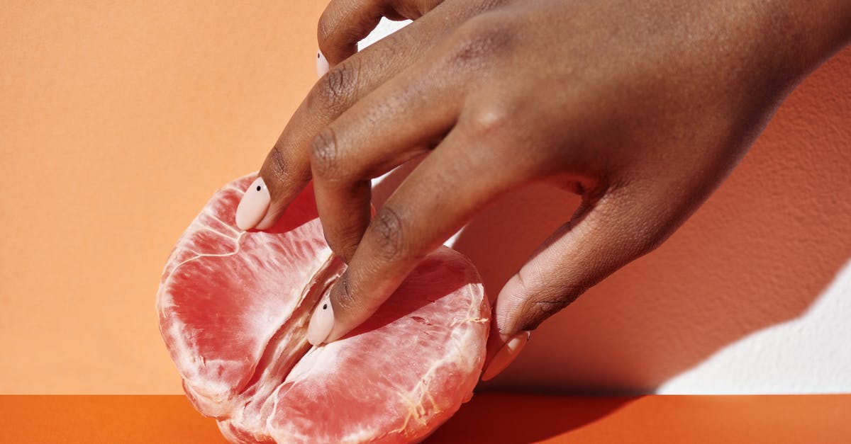 What to do with grapefruit seeds? - Person Holding Raw Meat on Orange Table