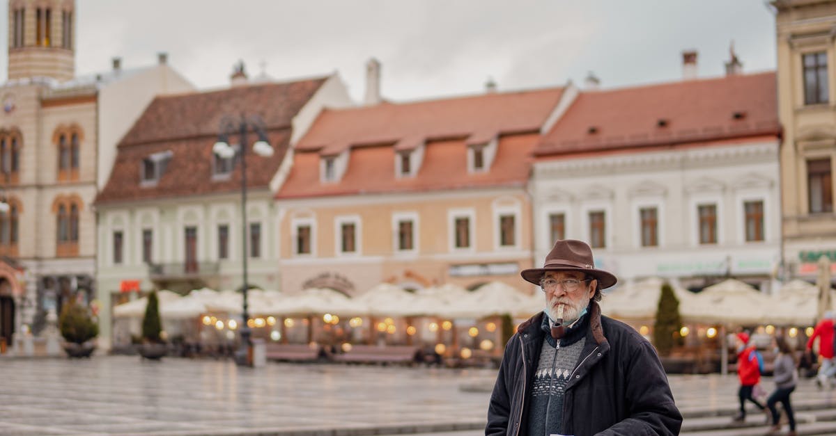 What to do with old coffee beans? - Man in Black Jacket and Black Pants Standing on Sidewalk