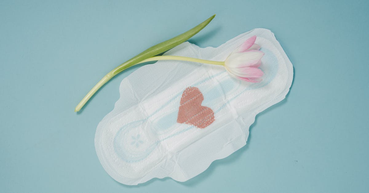 What to do with unused scallops' roe? - Feminine hygiene pad and pink tulip placed on blue background