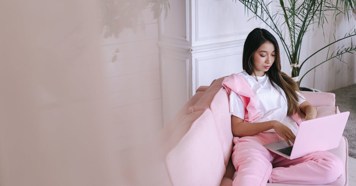 What to look for in a pot? - Woman Sitting on Pink Sofa Using a Laptop
