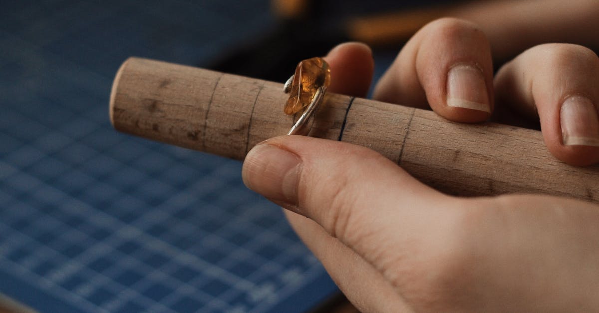 What tools are needed for making wafer cookies? - Person Holding a Silver Ring With Gemstone on a Wooden Tube