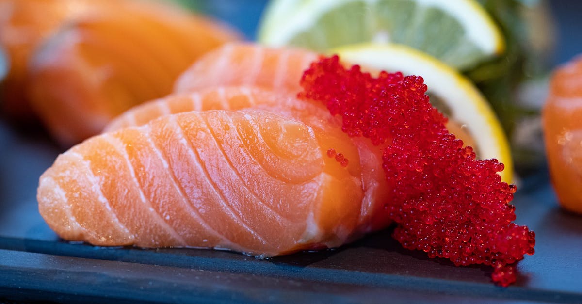 What type of fish would be best suited for a trio pairing of sashimi, crudo and ceviche? - Close-Up Photo of Sliced Salmon