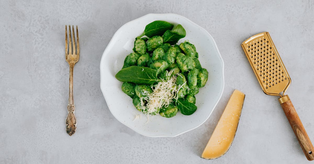 What vegan substitutes are available for cheese? - Overhead Shot of a Gold Fork Beside a Plate with Gnocchi and Spinach Leaves