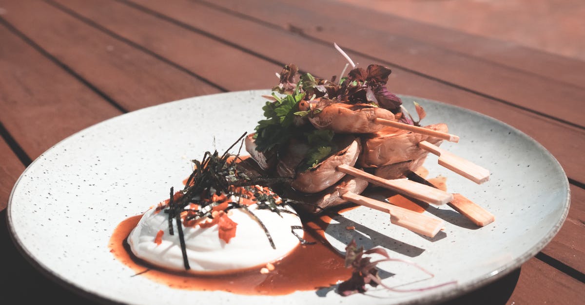 What was Country Herb Chicken Sauce Blend? - Fresh cooked meat on skewers near poached egg and herbs with sauce on plate on wooden table in terrace in daylight