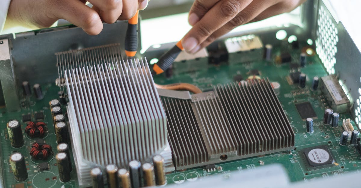 What was wrong with using White Truffle Oil? - Crop technician checking contacts on motherboard in workshop