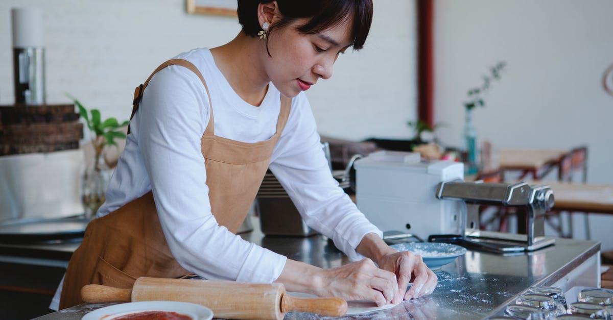 What would cause dough not to rise while making no-knead bread? - Woman in White Long Sleeves and Apron Making Pastry Dough