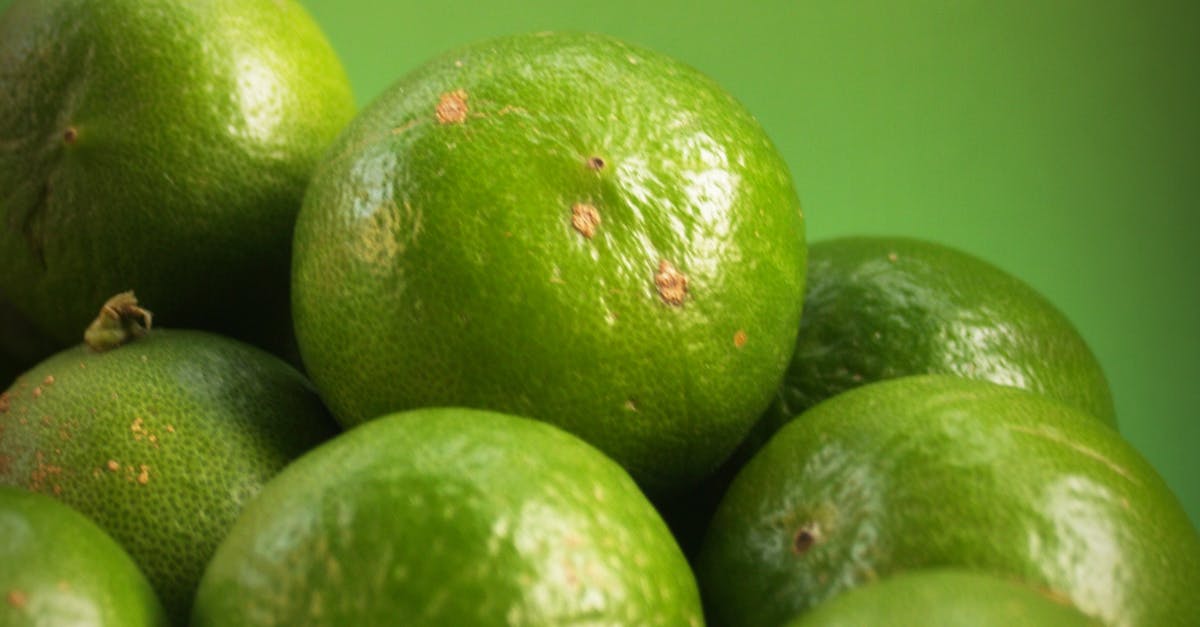 What would cause the peel of a lime to turn yellow? - Closeup Photography of Limes