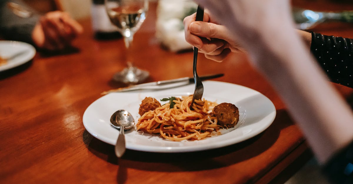 When a recipe calls for Wine, does it make a difference what wine to use? - Crop anonymous female enjoying tasty yummy spaghetti with meat ball and glass of white wine in restaurant