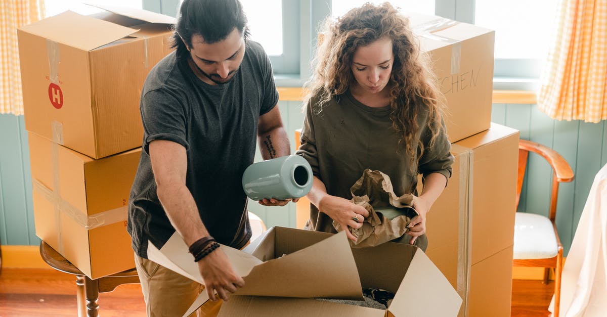 When a recipe calls or 1/2 cup of raisins, should the raisins be packed or not packed? - Multiethnic couple packing belongings in parchment near pile of boxes
