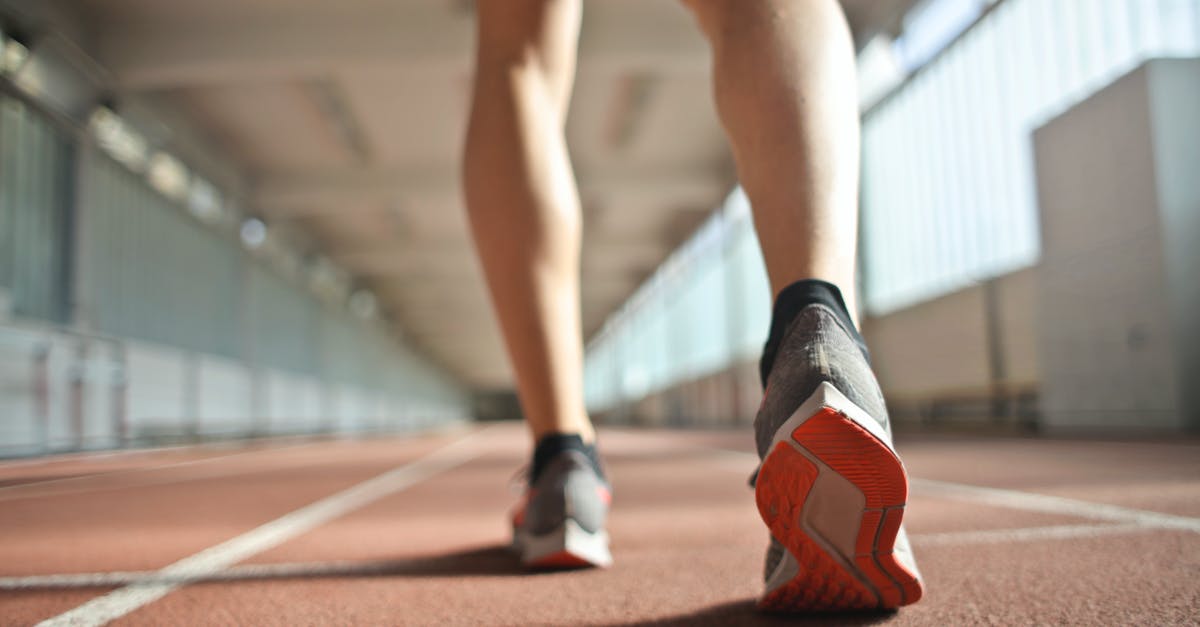 When are cornichons ready to be pickled? - Fit runner standing on racetrack in athletics arena