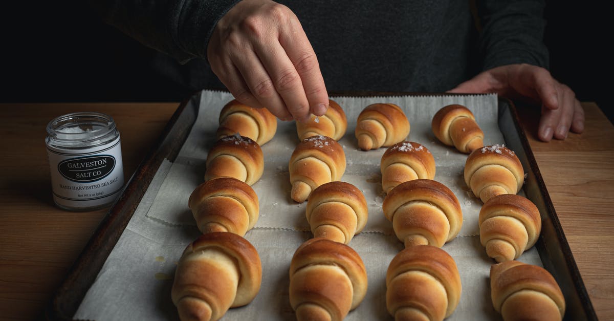 When baking what works well as a sugar substitute? - Person Topping Freshly Baked Bread with Sugar