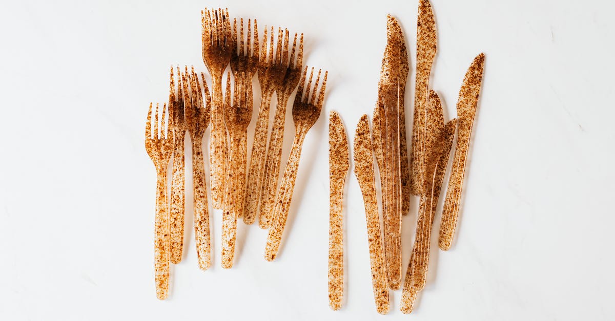 When basil gets brown spots, is it still usable? - Top view of heap disposable plastic forks folded chaotically on white surface placed near bunch disposable plastic knives