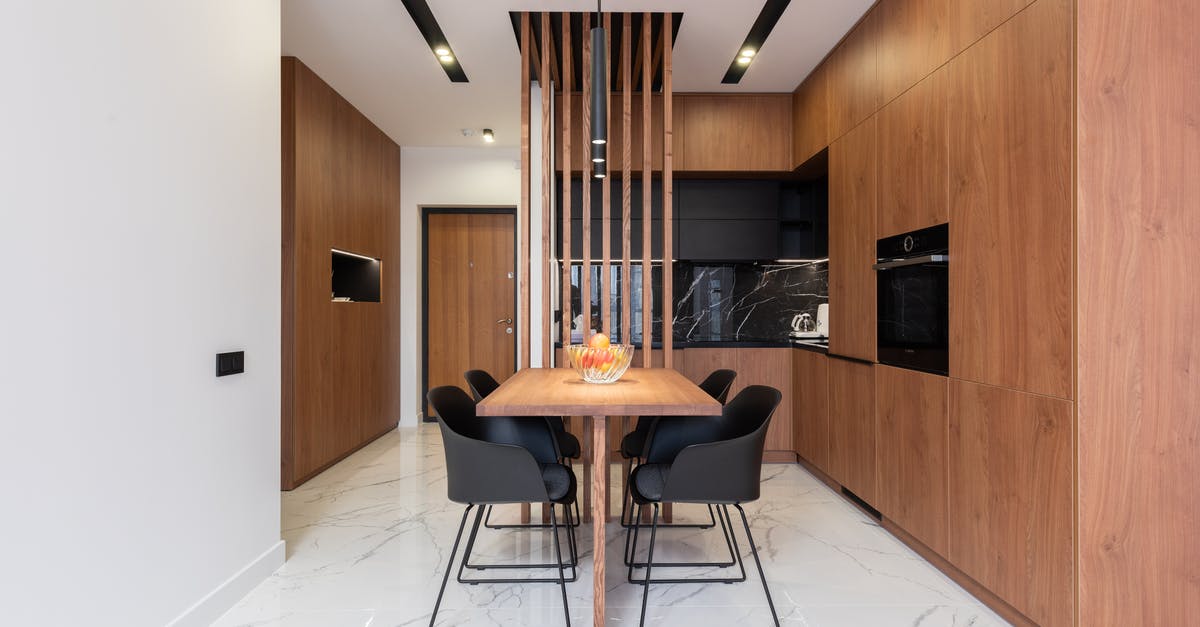 When does the new home oven/stove smell go away? - Stylish kitchen with wooden furniture and dining zone