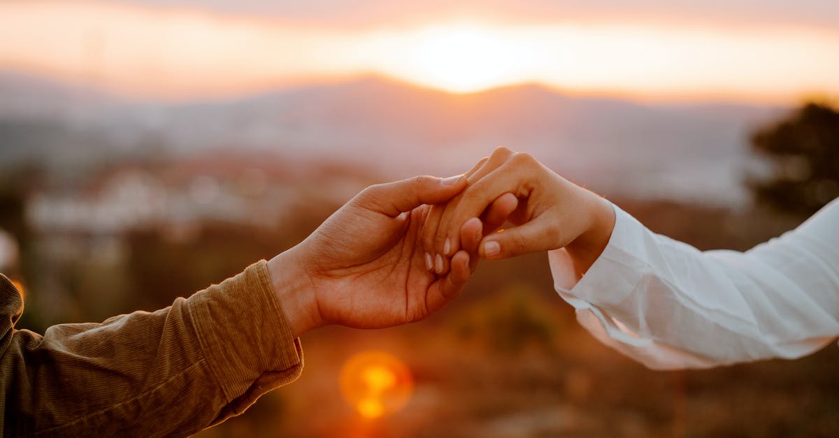 When is the expiry date? [closed] - Unrecognizable couple holding hands at sunset