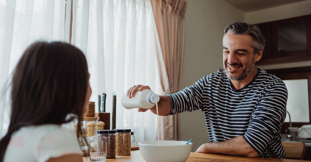 When milk is poured into cereal, what is it? [duplicate] - Father Pouring Milk Into Daughters Cereal