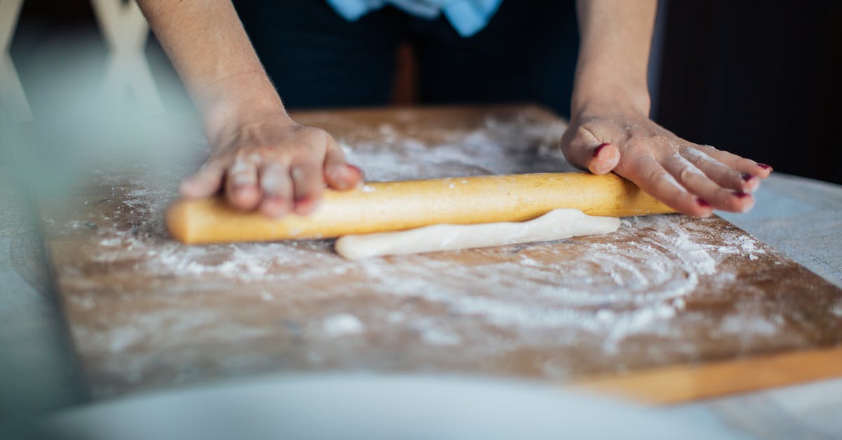 When should I knead with oil and when with flour? - Person Holding Brown Wooden Rolling pin
