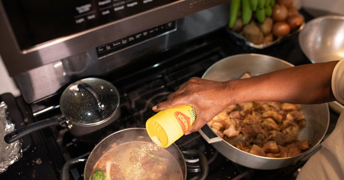 When skimming fats (while boiling meat), what percentage does it reduce? - Person Holding Yellow Plastic Bottle