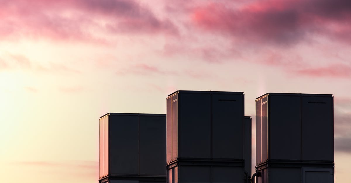 Which containers to boil dulce de leche for 7 hours? - Low-angle Photography of Three High-rise Buildings Under a Purple Sky