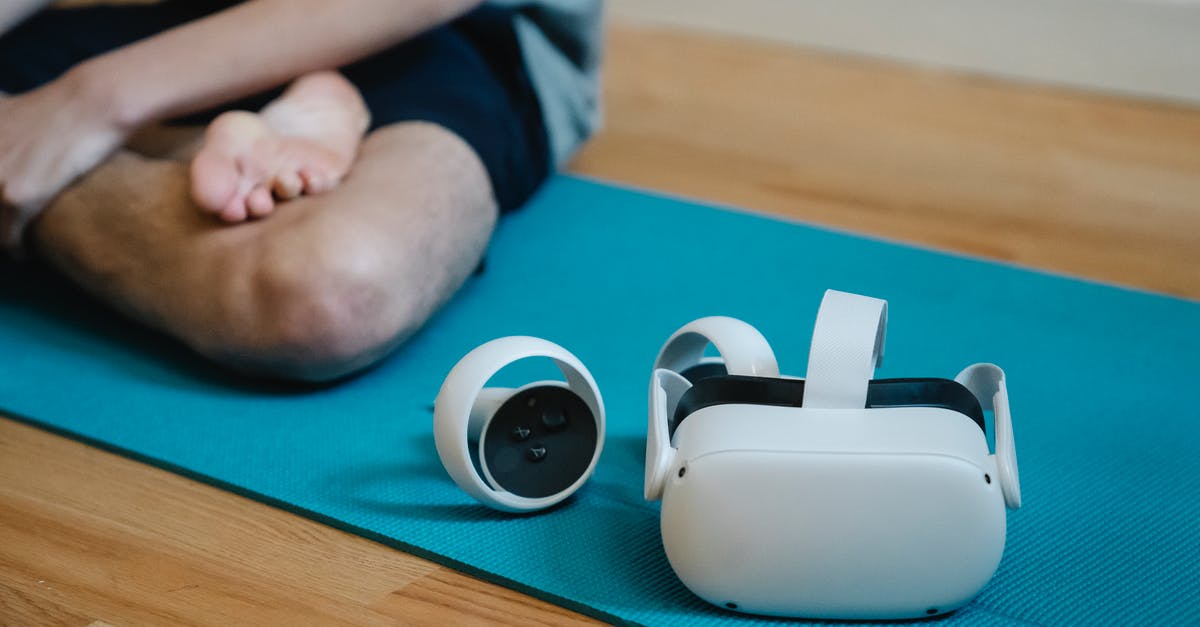 Which cooking device allows flexible temperature programming? - VR glasses on mat near person with crossed leg