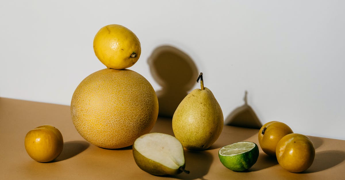 Which has more citric acid, lemon or lime? - Green and Yellow Fruits on Brown Surface