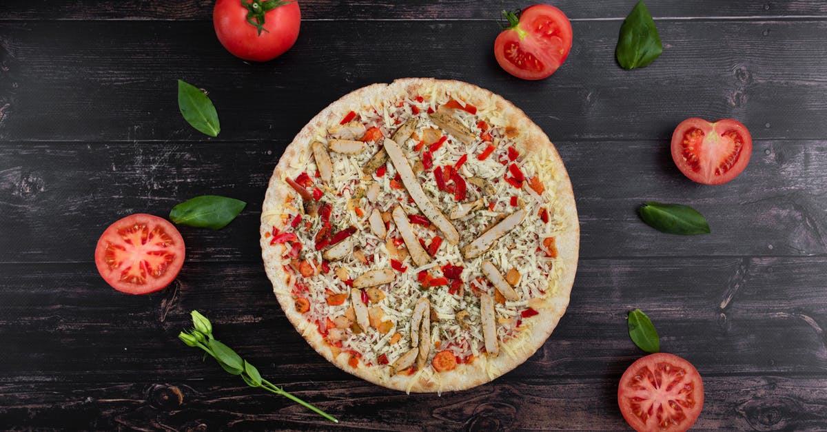 Which ingredient gives Chicken Pate its flavor? - Yummy pizza near cut tomatoes and basil leaves