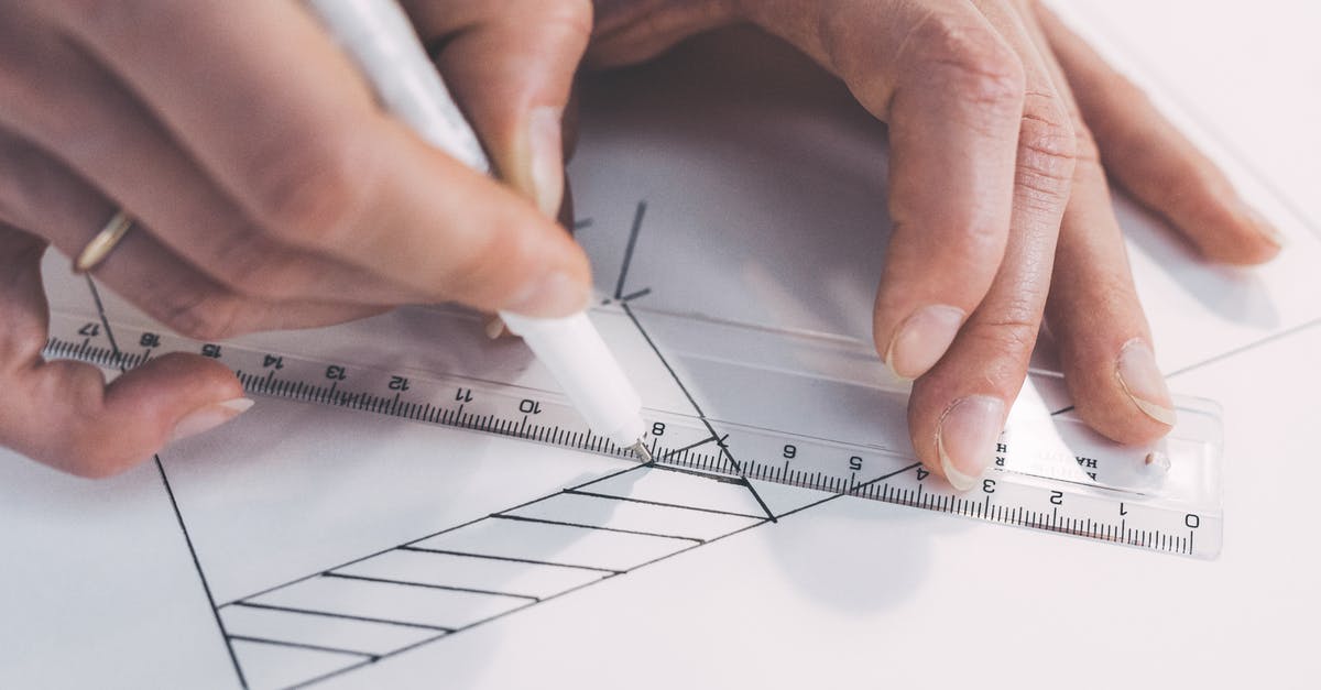 Which measuring scale should I buy? - Close Up Photo of Person Drawing Lines on Paper with a Ruler and Pen
