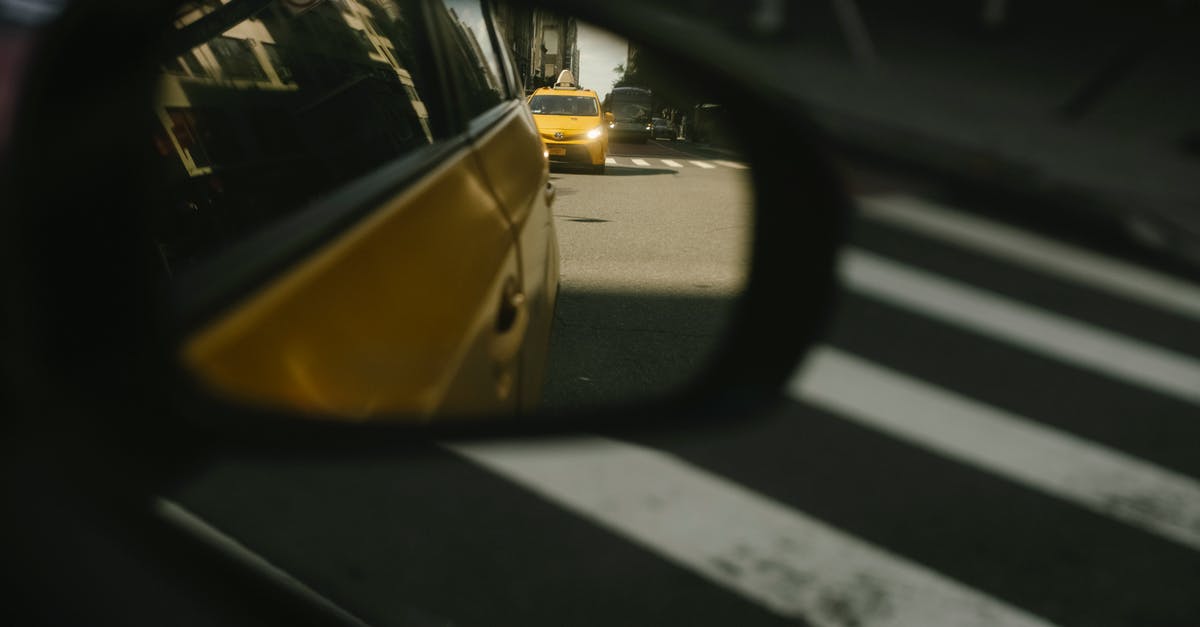 Which side of the oven tray is the front one? Why? - Modern taxi cars driving on road with crosswalk