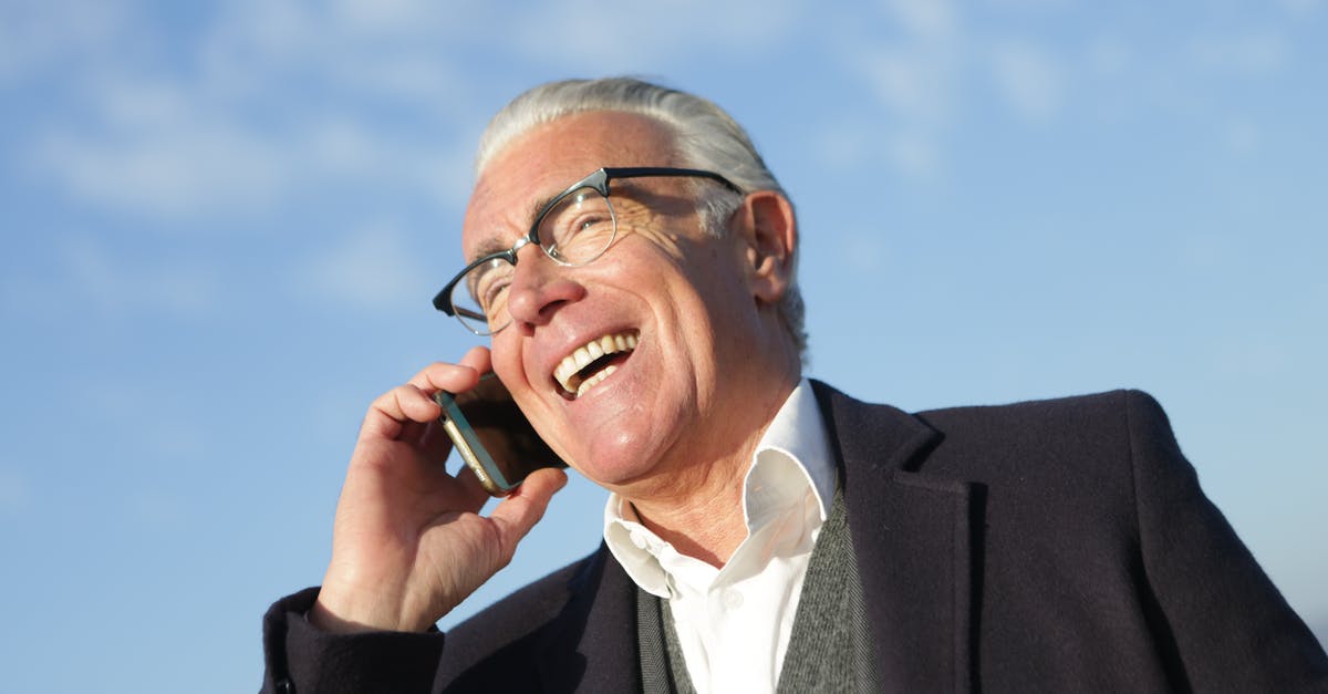 Which thickeners work well with dairy? - From below of delighted aged male entrepreneur in classy outfit standing on street and speaking on cellphone while laughing and looking away