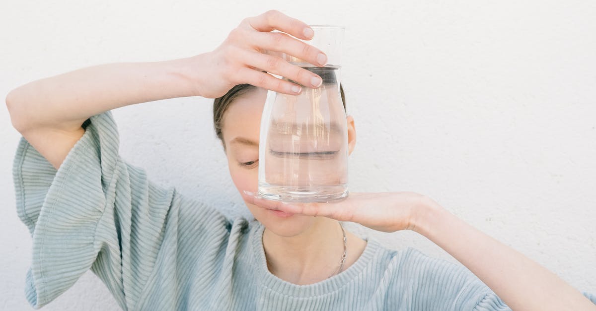 Whiskey and Water - Woman in Blue Crew Neck Shirt Holding Clear Glass Jar