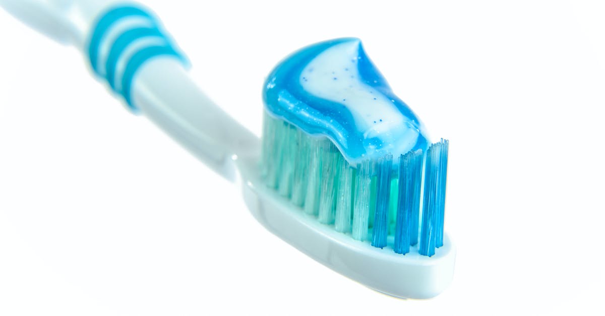 White bristles on carrots - Blue and White Toothpaste on Toothbrush